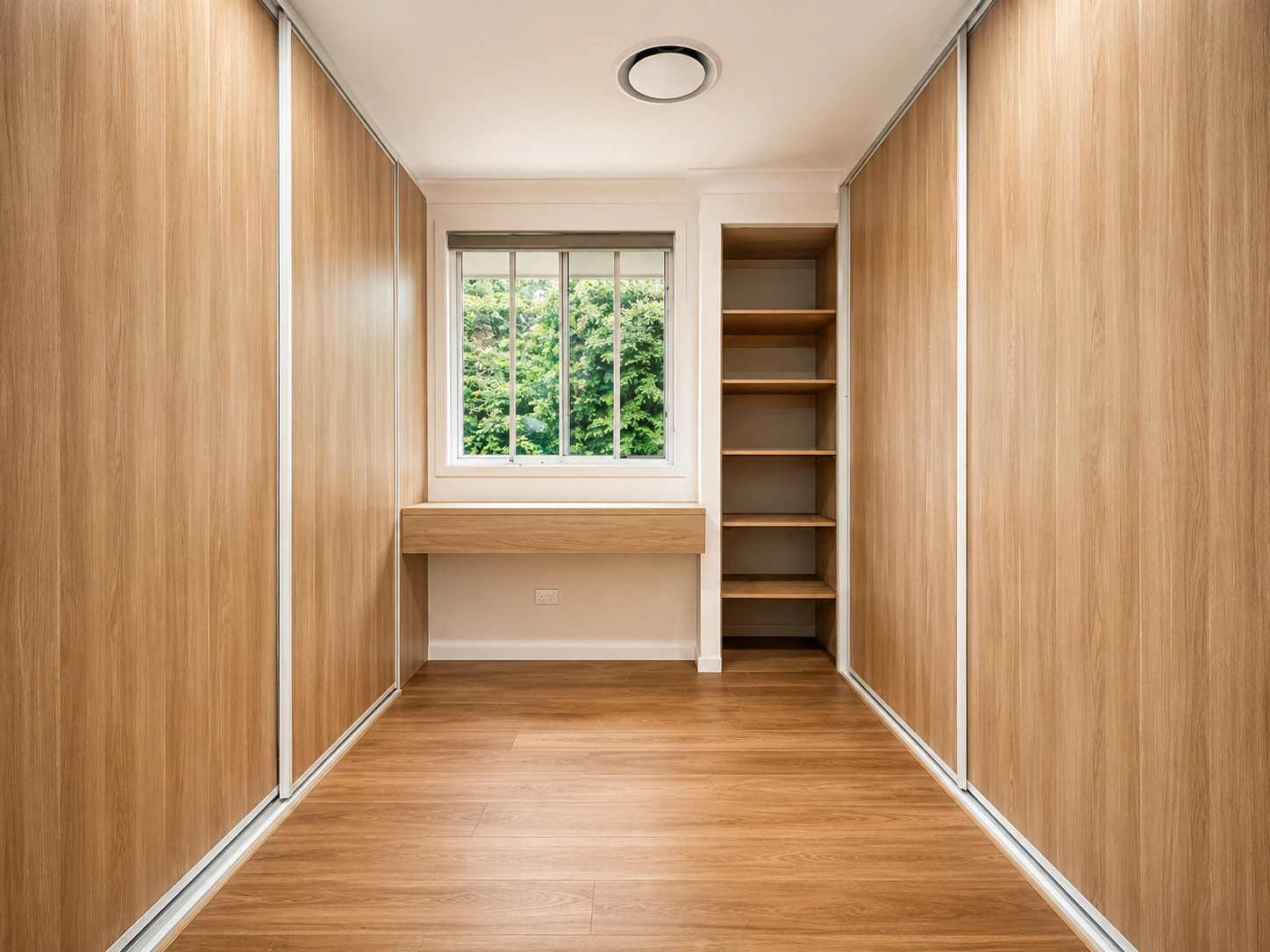 Walk-in robe added in the Castle Hill renovation — full-height oak sliding wardrobes, open shelving and a built-in desk under the window
