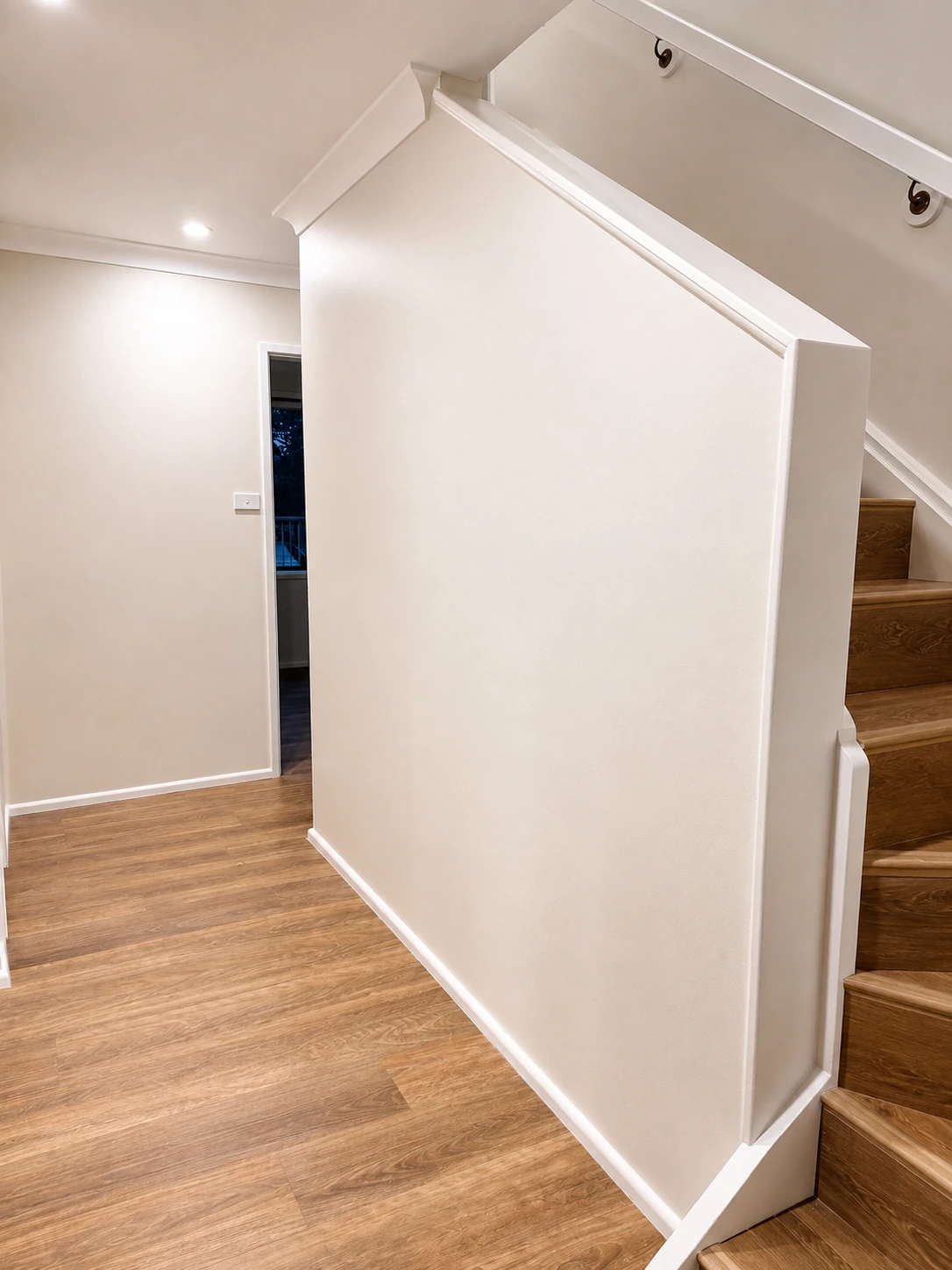 Castle Hill home — timber staircase and hallway with warm timber-look flooring