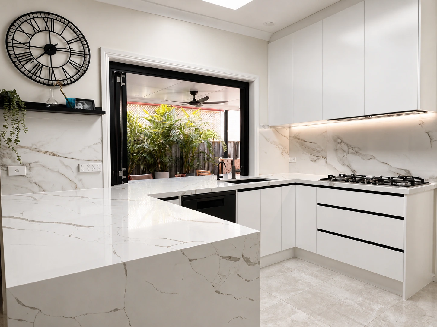 Castle Hill kitchen — white handleless cabinetry and marble-look waterfall island opening to a covered alfresco