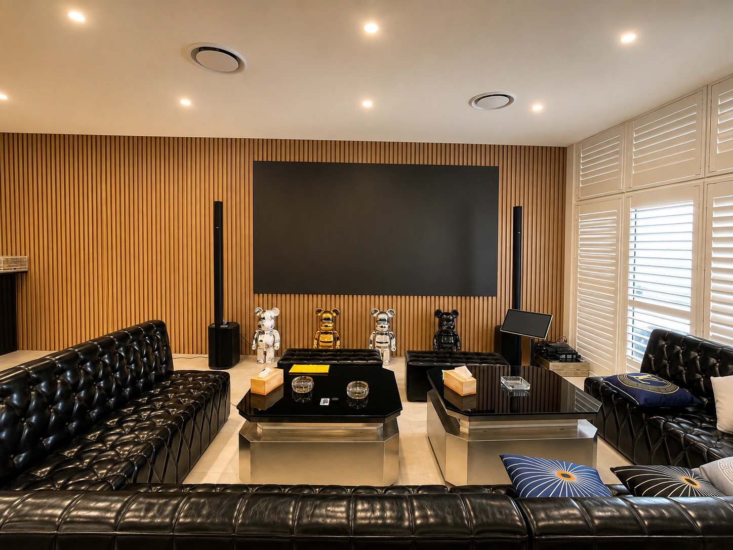Silverwater karaoke and theatre lounge — black tufted leather seating against an acoustic timber-slat wall