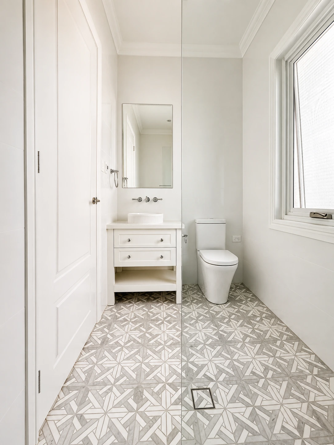 Willoughby powder room — white shaker vanity with a vessel basin and a patterned star-mosaic floor