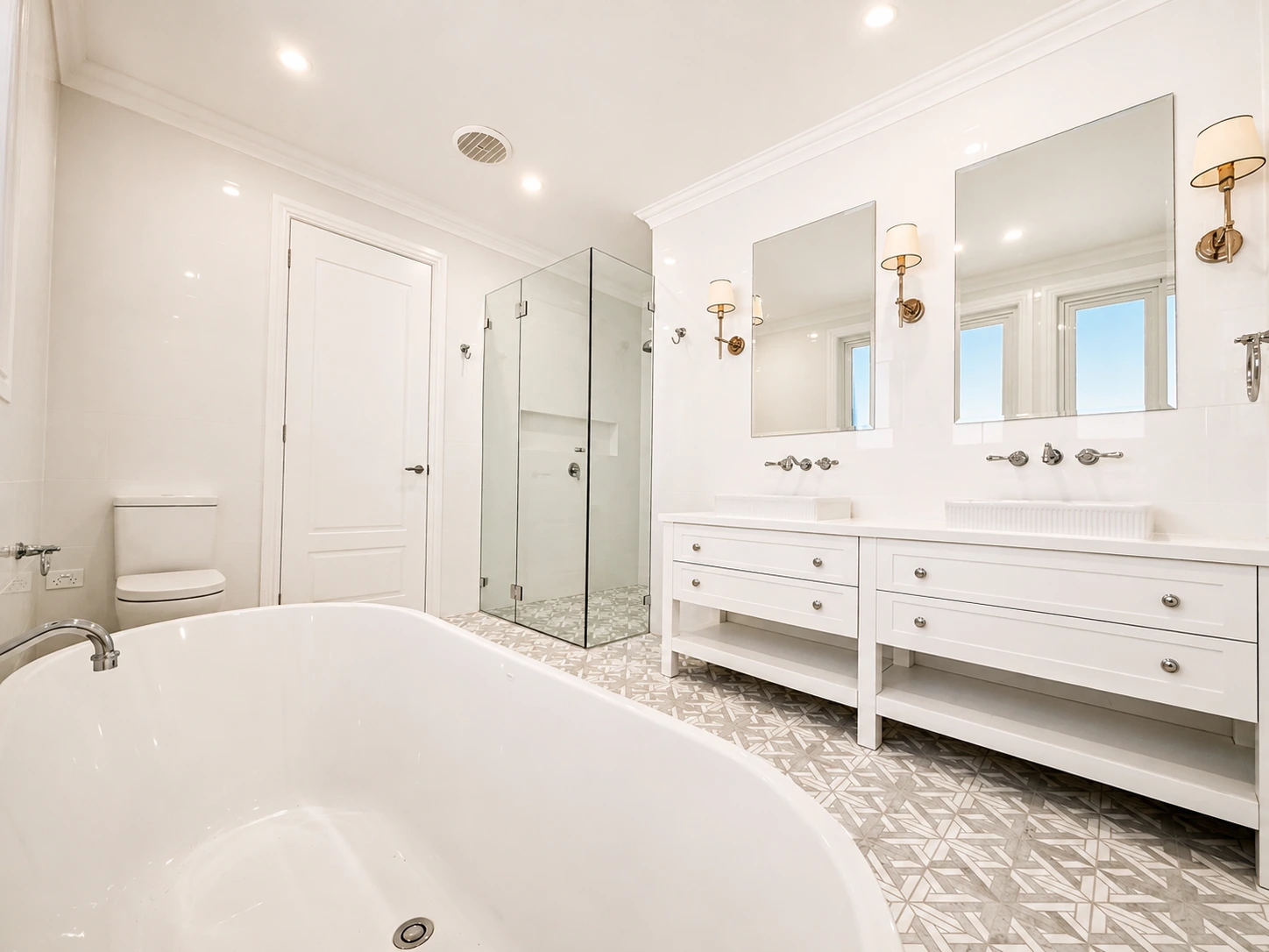 Willoughby main bathroom — freestanding bath, frameless glass shower and double vanity on a star-mosaic floor